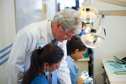 Dr. Joseph McManus works with students in the clinic lab.