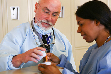 Dr. Thomas Boyle helps a student in the clinic